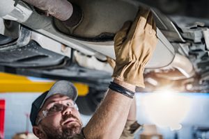 Closeup,Of,Car,Catalytic,Converter,Being,Checked,By,Professional,Mechanic - Meineke Carolinas Meineke Car Care | Catalytic Converter | Mooresville